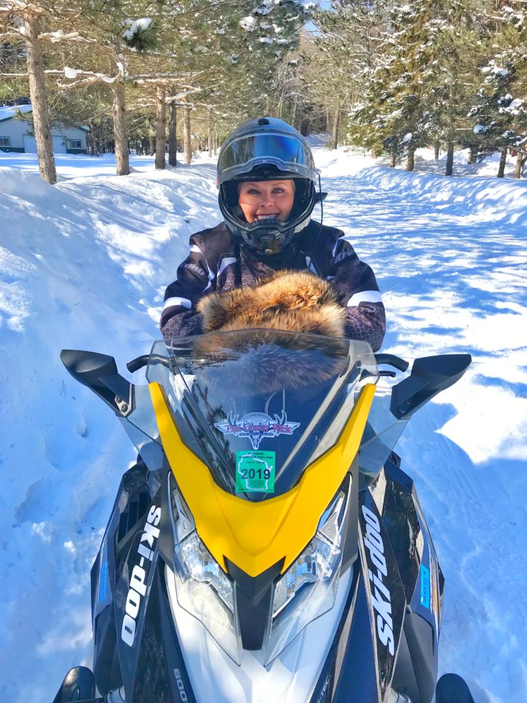 woman on snowmobile - Hayward Lakes Blog
